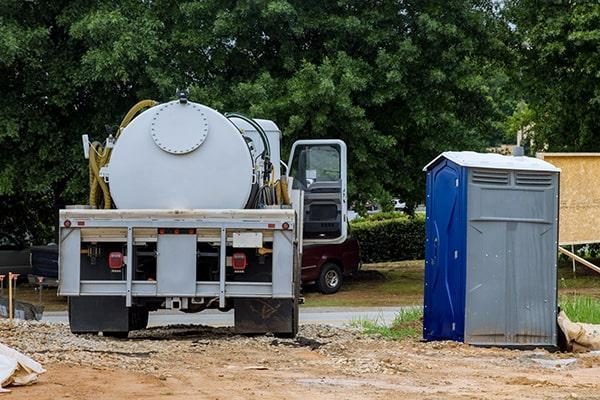 Service truck maintaining a portable restroom unit